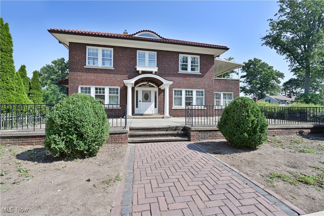 24510 Lake Road Bay Village, OH 44140 - Photo 1 of 45 View of front facade featuring a tile roof and brick siding