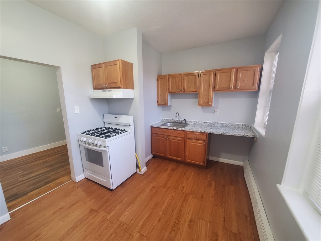 10 Abbotsford Street, Unit 9 Boston, MA 02121 - Photo 1 of 14 a kitchen with stainless steel appliances a sink and a stove top oven