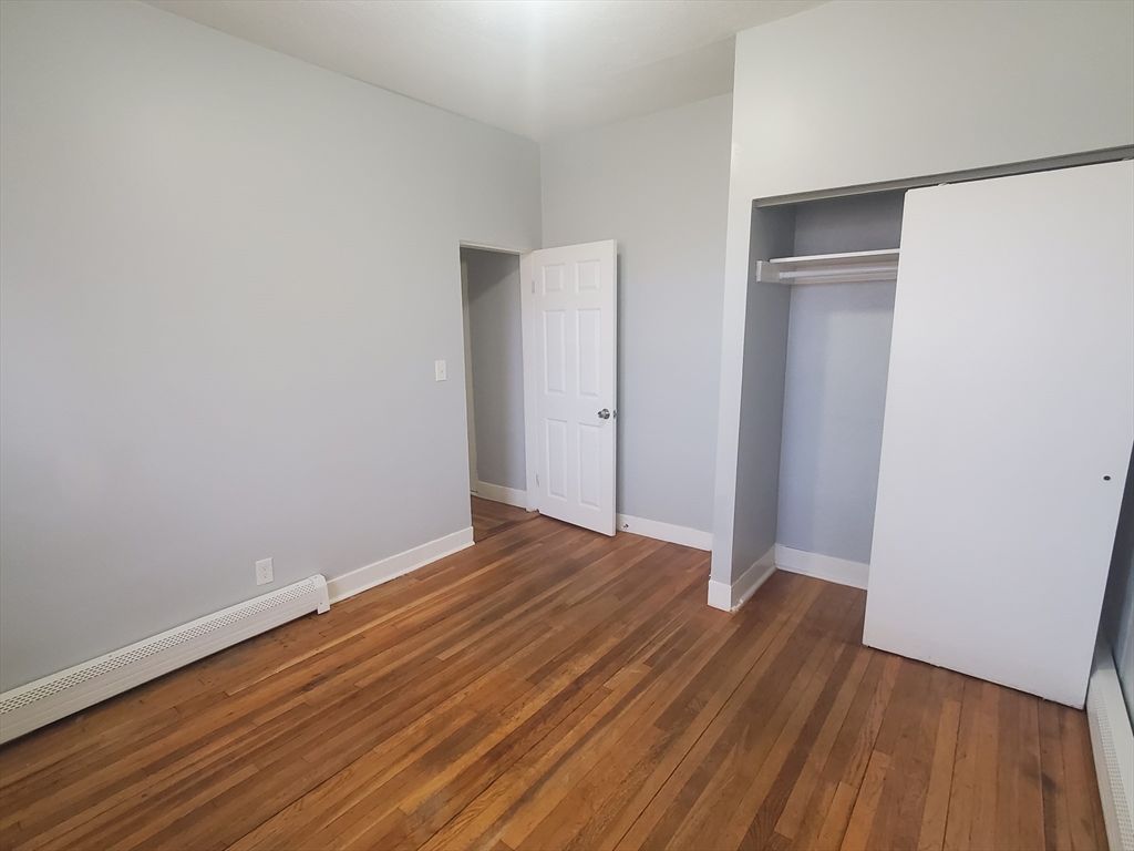 10 Abbotsford Street, Unit 9 Boston, MA 02121 - Photo 13 of 14 a view of an empty room with wooden floor