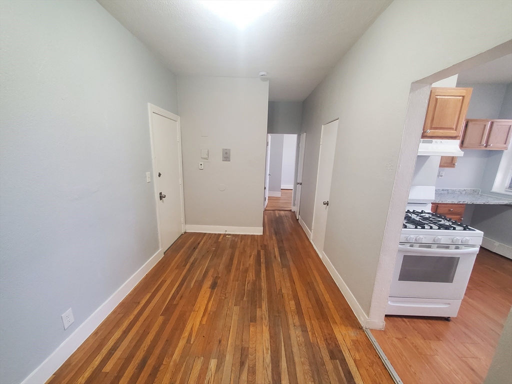 10 Abbotsford Street, Unit 9 Boston, MA 02121 - Photo 4 of 14 a view of a room with wooden floor and closet