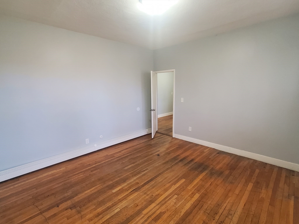 10 Abbotsford Street, Unit 9 Boston, MA 02121 - Photo 8 of 14 a view of an empty room with wooden floor