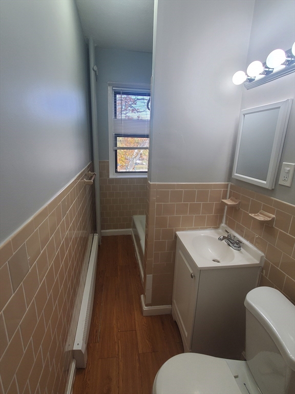 10 Abbotsford Street, Unit 9 Boston, MA 02121 - Photo 9 of 14 a bathroom with a toilet sink and mirror