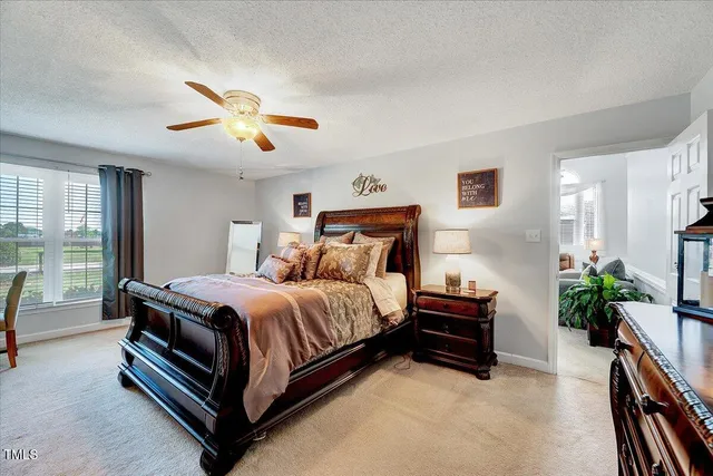 a spacious bedroom with a bed and a chandelier