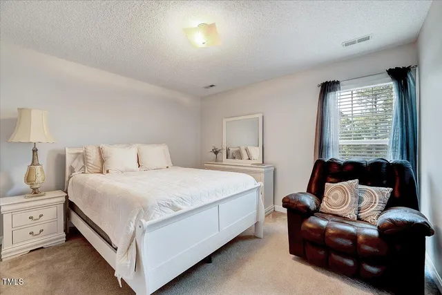 a bedroom with a bed and a couch