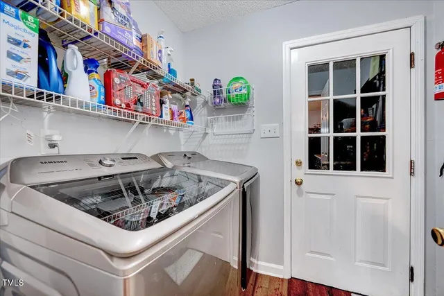 a kitchen stove top oven a sink and dishwasher with white cabinets