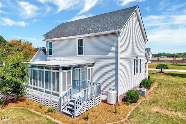 a view of a house with backyard and sitting area