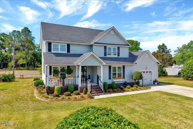 a front view of a house with garden