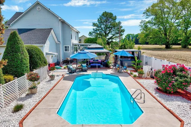 a view of a swimming pool with furniture