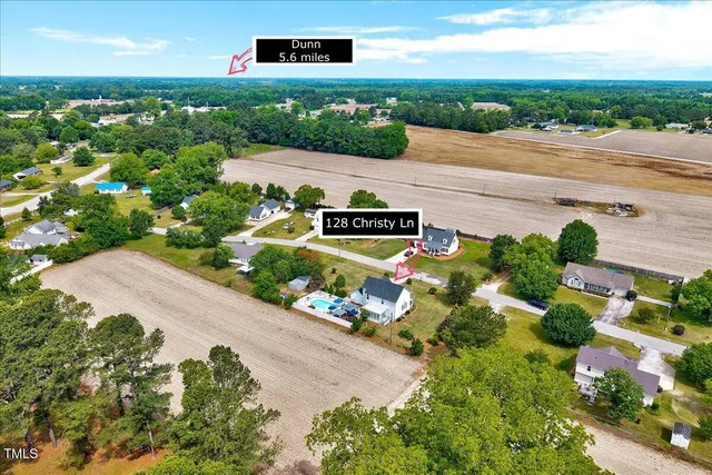an aerial view of a house with a garden and lake view