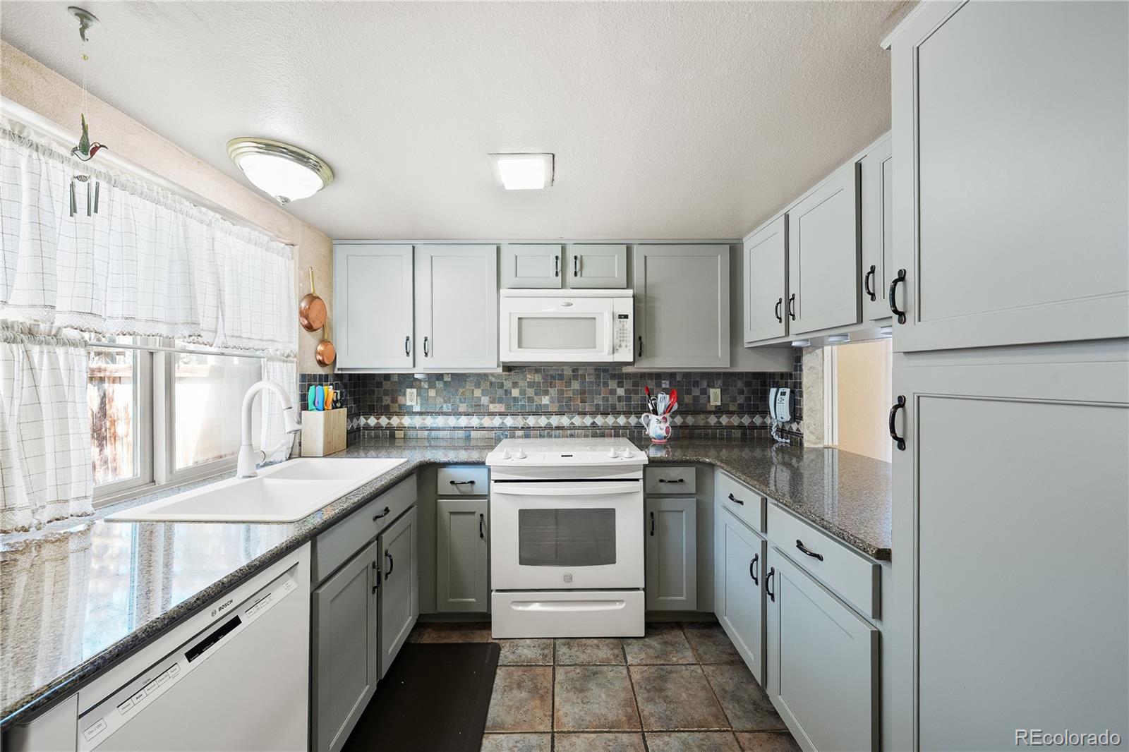 3657 South Laredo Street, Unit A Aurora, CO 80013 - Photo 11 of 26 a kitchen with a sink stove and refrigerator