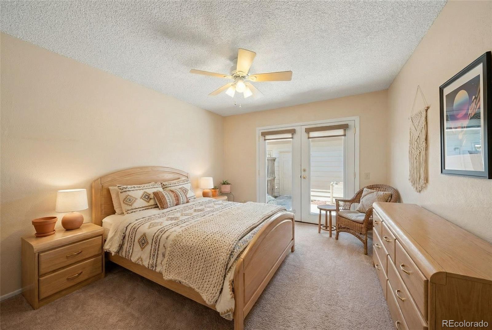 3657 South Laredo Street, Unit A Aurora, CO 80013 - Photo 14 of 26 a bedroom with a bed and a chandelier