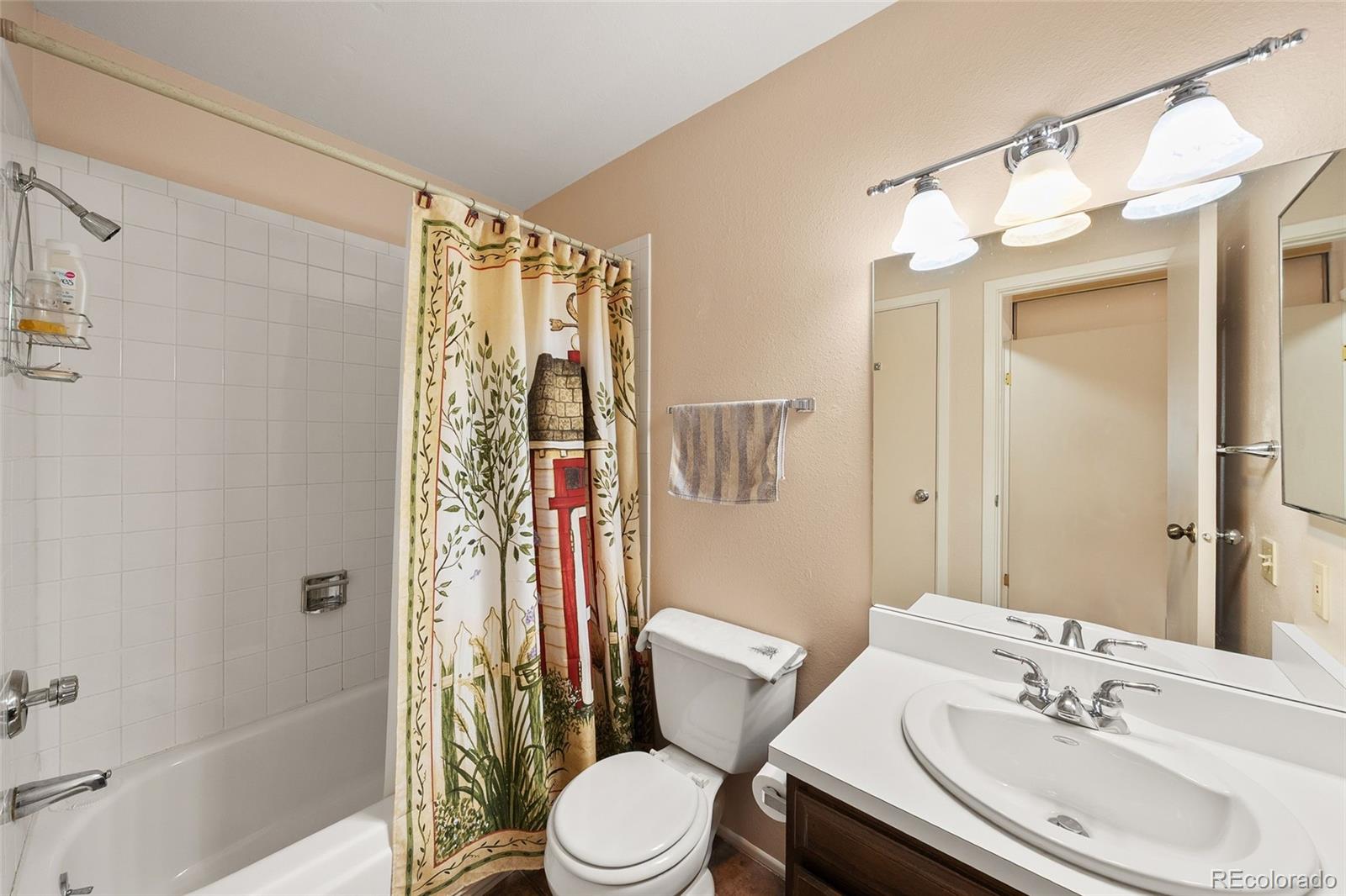 3657 South Laredo Street, Unit A Aurora, CO 80013 - Photo 15 of 26 a bathroom with a sink toilet and shower