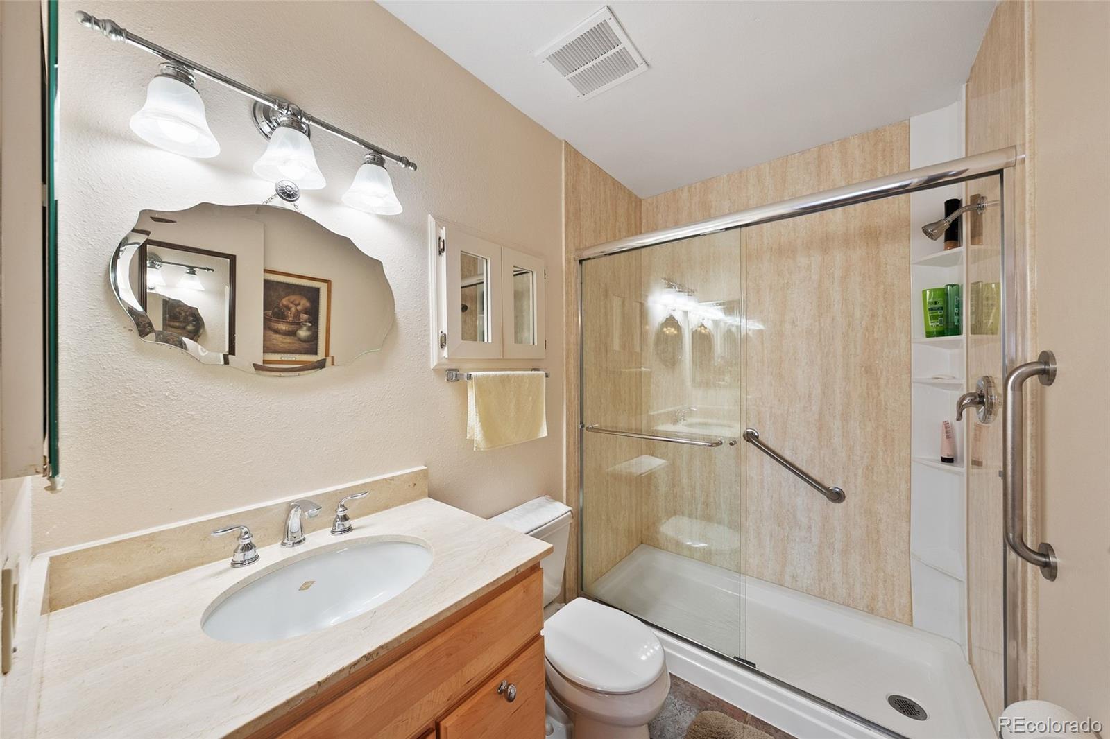3657 South Laredo Street, Unit A Aurora, CO 80013 - Photo 18 of 26 a bathroom with a granite countertop sink toilet and shower