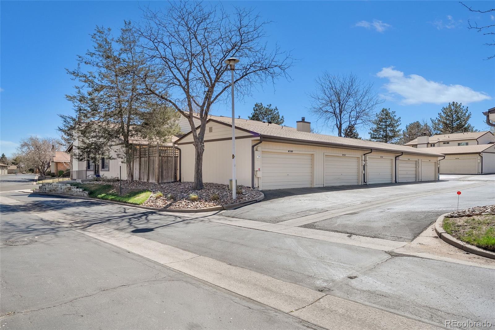 3657 South Laredo Street, Unit A Aurora, CO 80013 - Photo 21 of 26 a house with trees in front of it