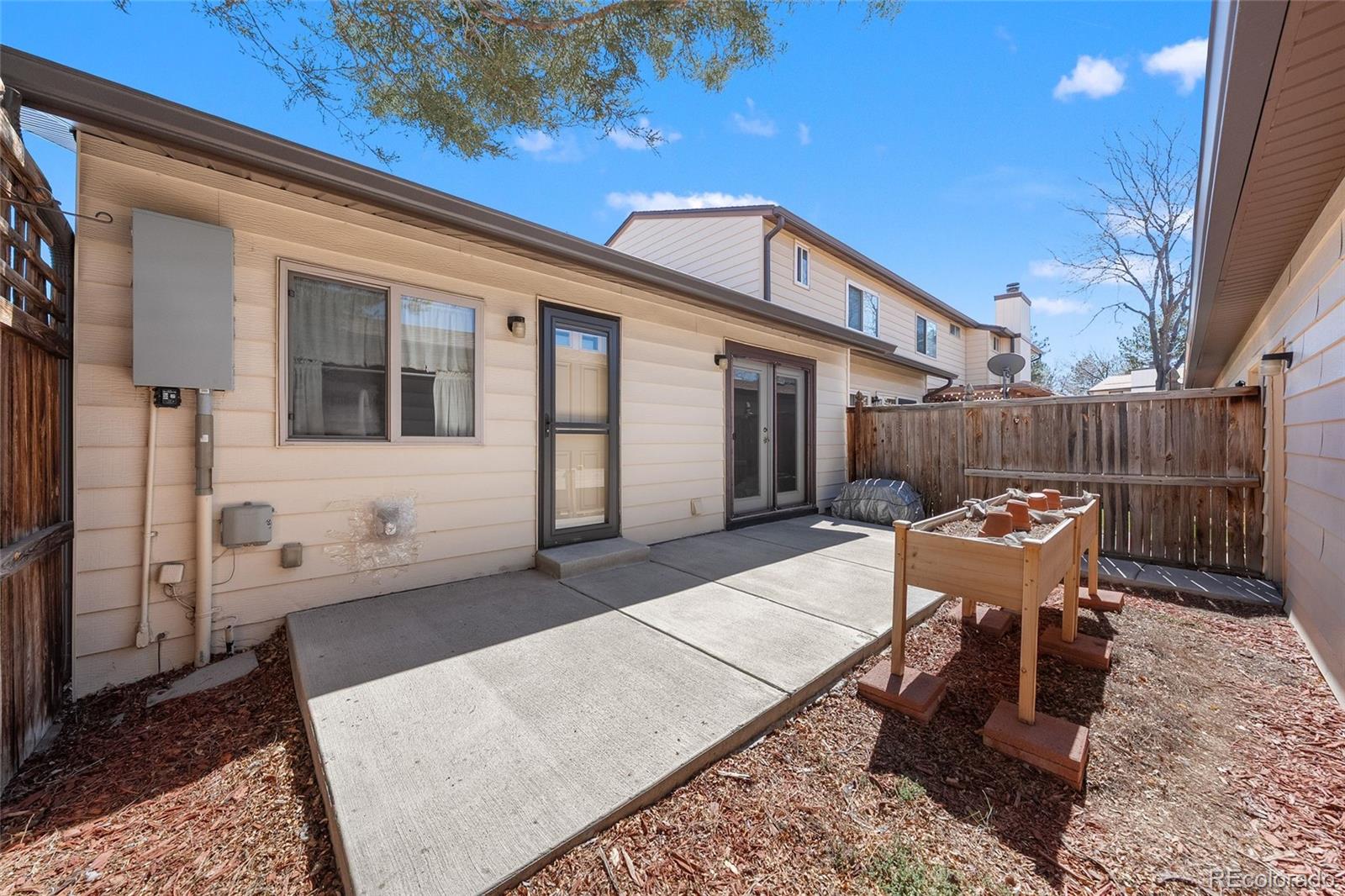 3657 South Laredo Street, Unit A Aurora, CO 80013 - Photo 23 of 26 a view of a patio with a table and chairs