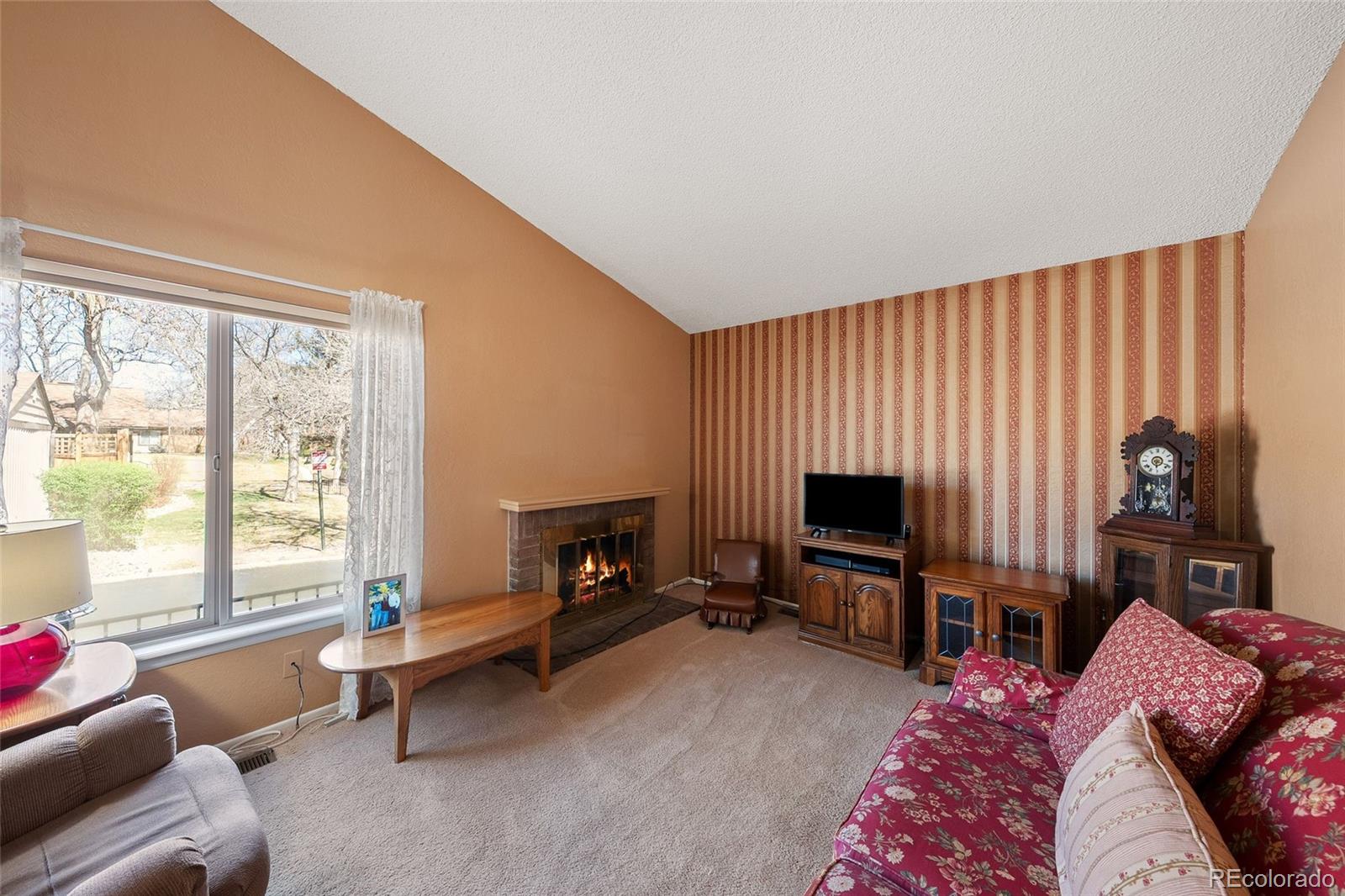 3657 South Laredo Street, Unit A Aurora, CO 80013 - Photo 7 of 26 a living room with furniture a flat screen tv and a fireplace