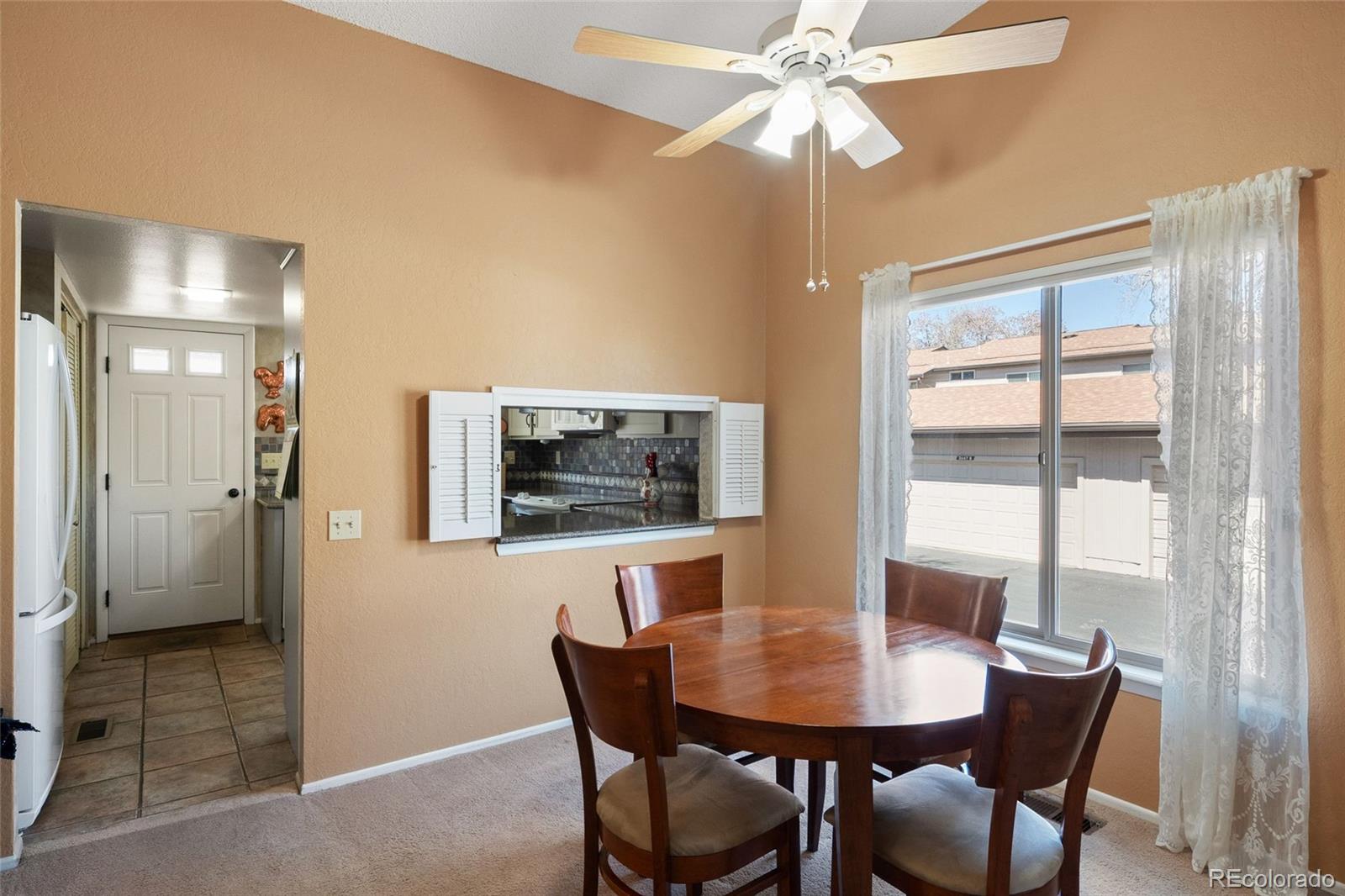 3657 South Laredo Street, Unit A Aurora, CO 80013 - Photo 9 of 26 a view of a dining room with furniture window and wooden floor