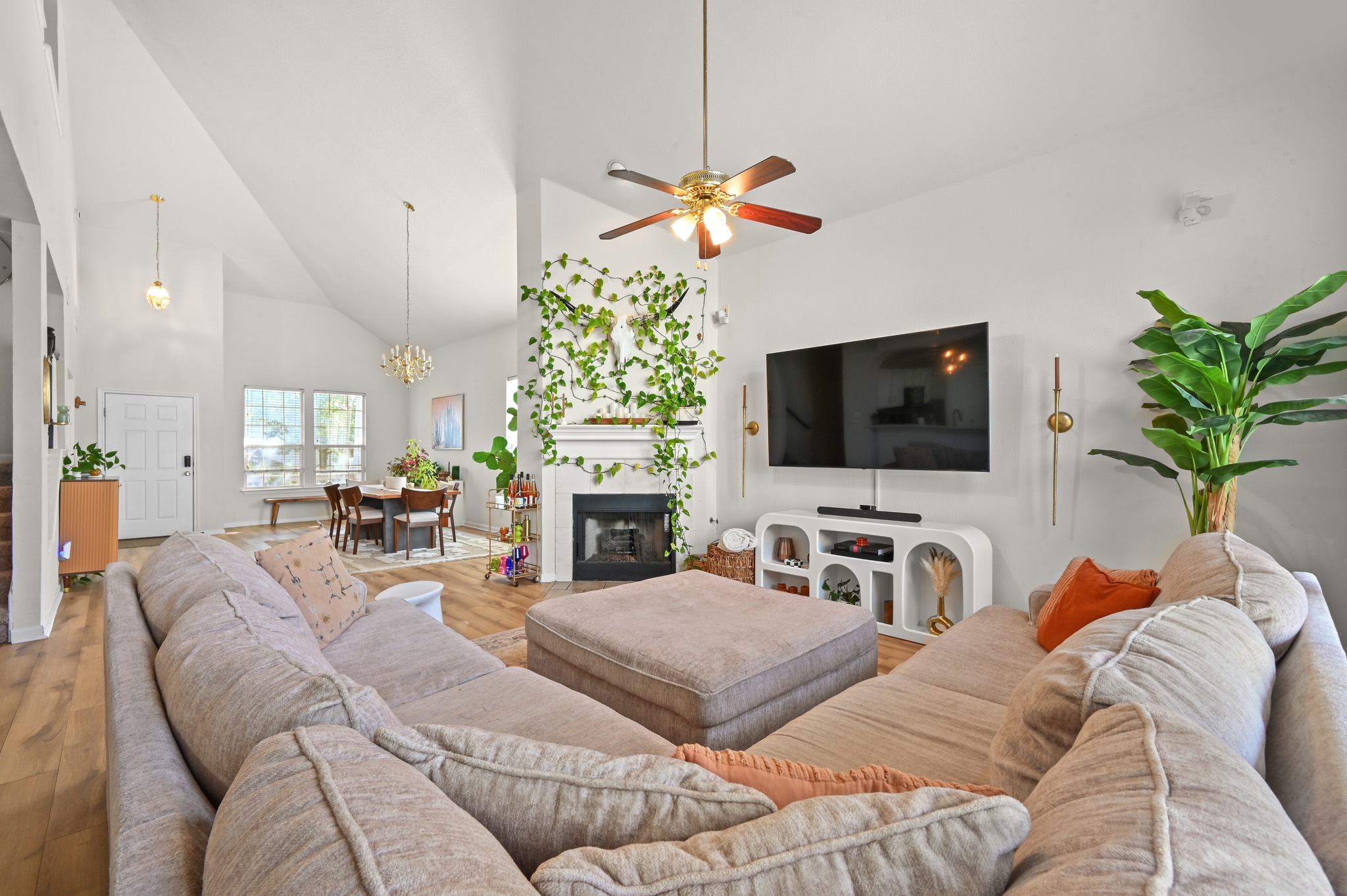 5888 Fergus Kyle, TX 78640 - Photo 4 of 40 Voluminous vaulted ceilings elevate this open-concept living space, anchored by a charming fireplace.