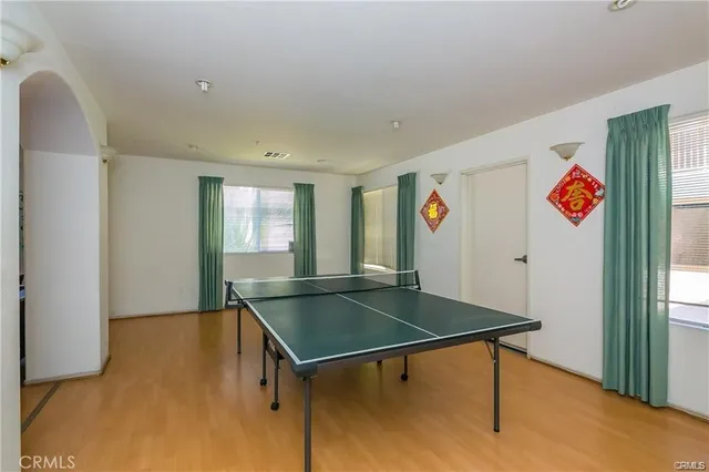 a view of staircase with lots of windows and flower plants