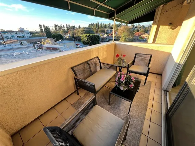 a balcony with table and chairs