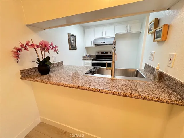 a kitchen with a sink and cabinets