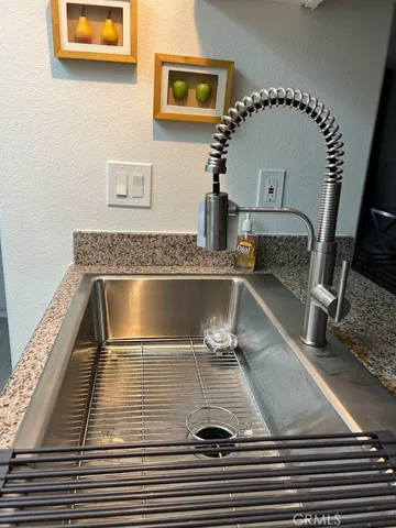 a kitchen with granite countertop a stove and a sink