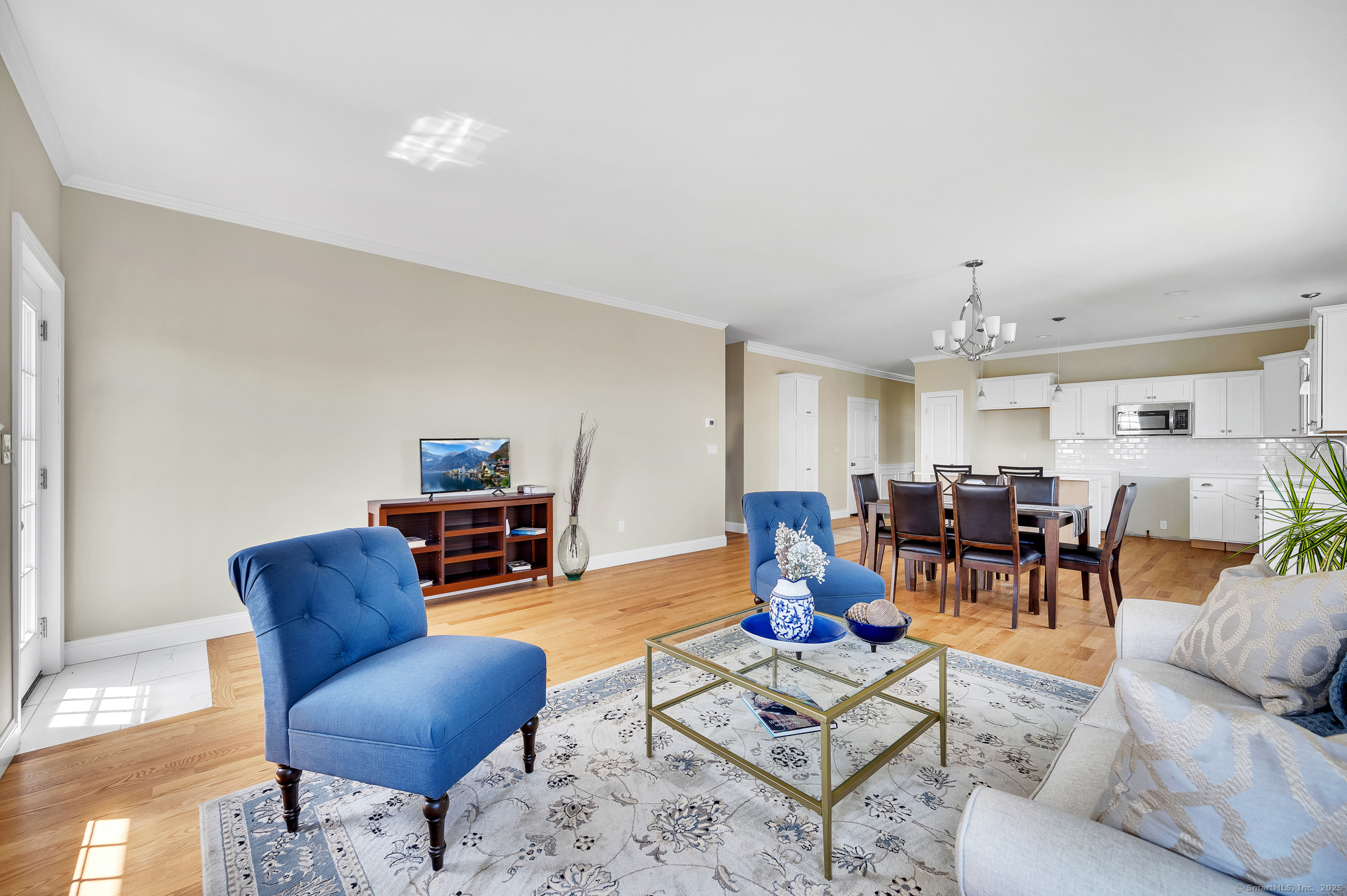 128 Webster Lane Middletown, CT 06457 - Photo 12 of 21 a living room with furniture and a dining table with wooden floor
