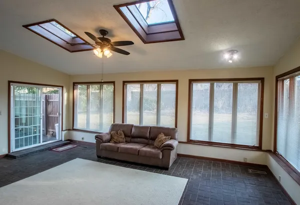 a living room with furniture and large windows