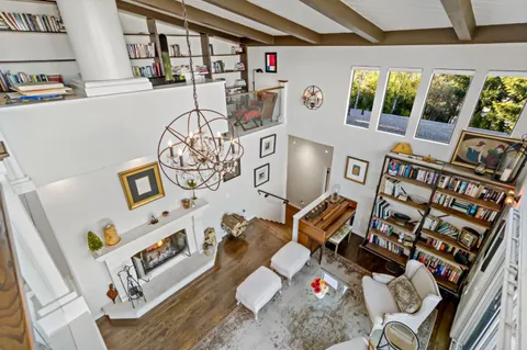 a living room with furniture and a floor to ceiling window