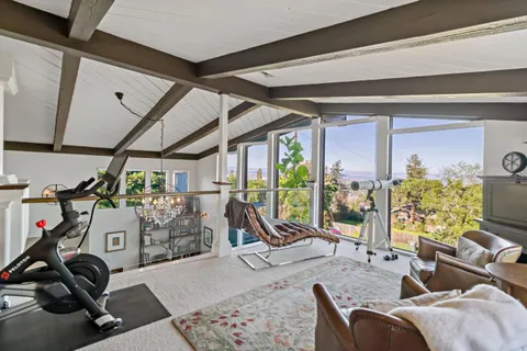 a view of a dining room with furniture a chandelier and wooden floor