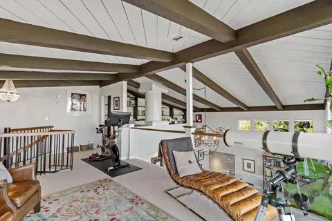 a living room with furniture a fireplace and wooden floor