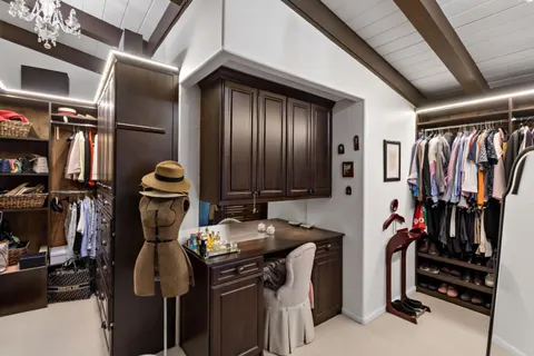a view of a balcony with chairs and wooden fence