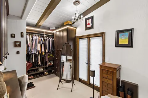 a view of a roof deck with couches and wooden floor