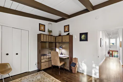 a view of a balcony with chairs and wooden floor