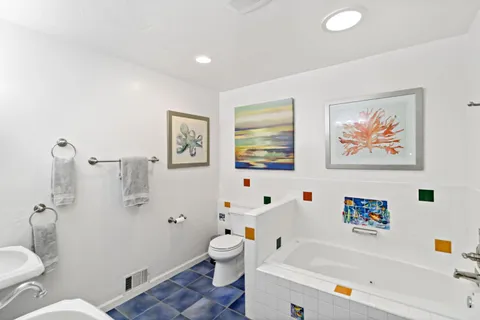 a view of a house with backyard sitting area and garden