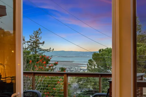 a living room with patio furniture and a wooden floor