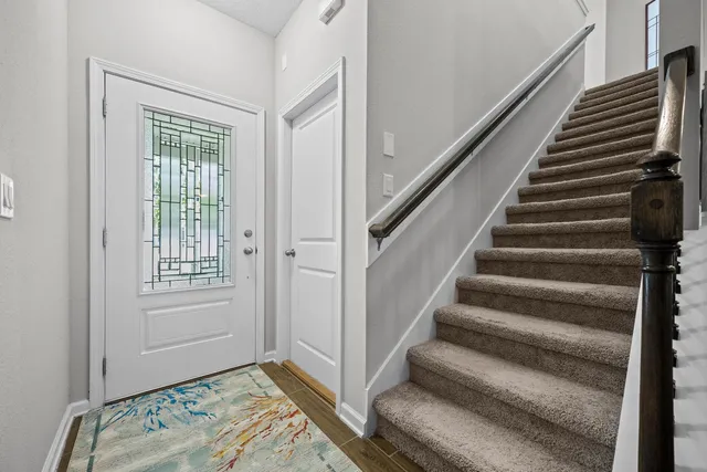 a view of a patio with couple of chairs and a potted plant