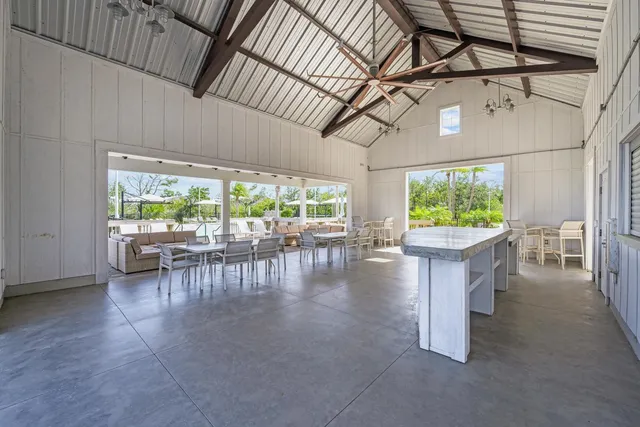 an aerial view of a house with a yard basket ball court and outdoor seating