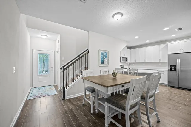 a view of a dining room with furniture and a wooden floor