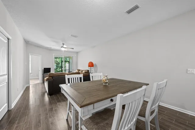 a kitchen with stainless steel appliances a sink cabinets and wooden floor