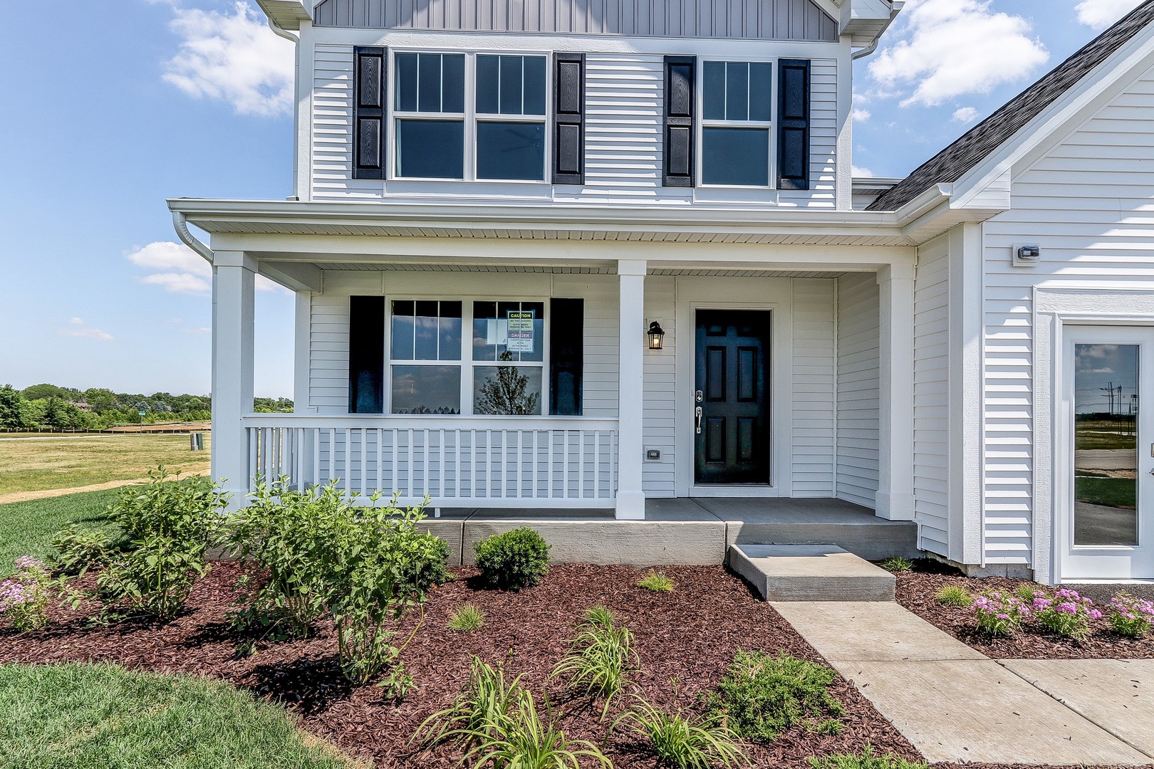 1033 Sharp Drive, Unit 1609 Plano, IL 60545 - Photo 2 of 35 a house view with a garden space