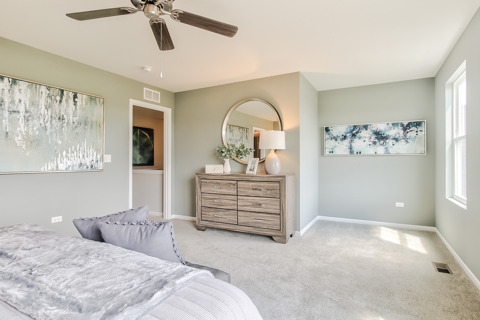 1033 Sharp Drive, Unit 1609 Plano, IL 60545 - Photo 22 of 35 a bedroom with a bed and a chandelier