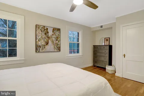 a bedroom with a large bed and a ceiling fan