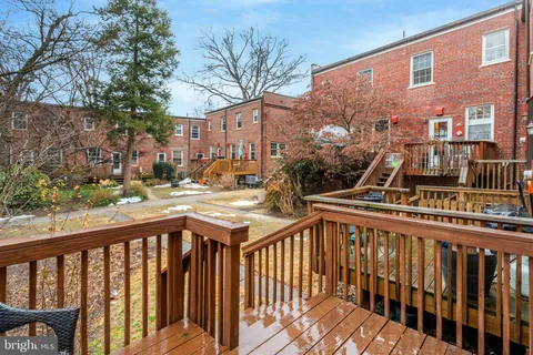 a view of a house with a wooden deck