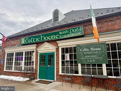 a view of a lush green forest with lawn chairs