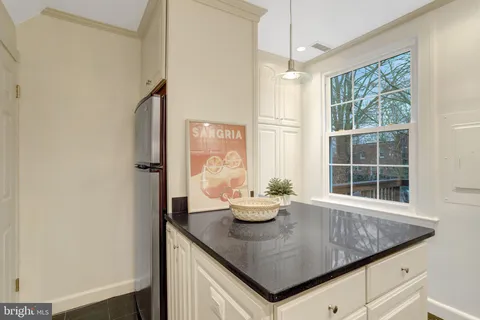 a kitchen with stainless steel appliances granite countertop a sink a stove and white cabinets