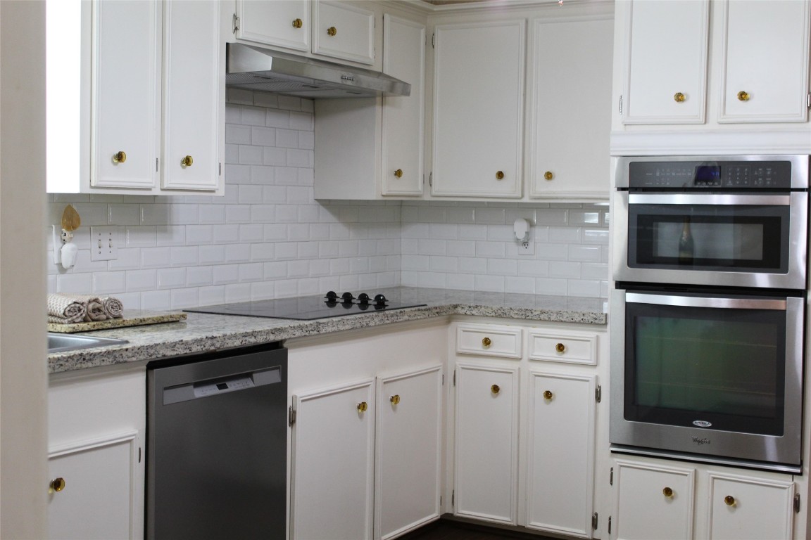 3706 Cypresswood Drive Spring, TX 77388 - Photo 13 of 30 a kitchen with granite countertop white cabinets stainless steel appliances and a sink
