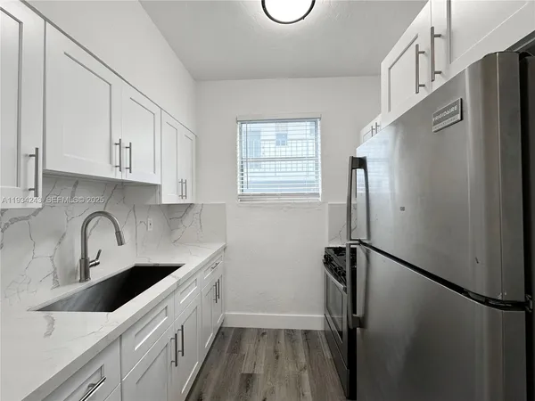 a kitchen with stainless steel appliances a refrigerator and a sink