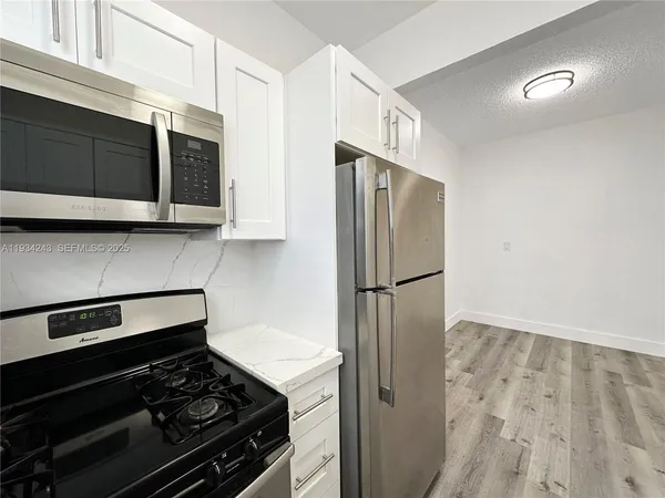 a kitchen with a stove and a microwave