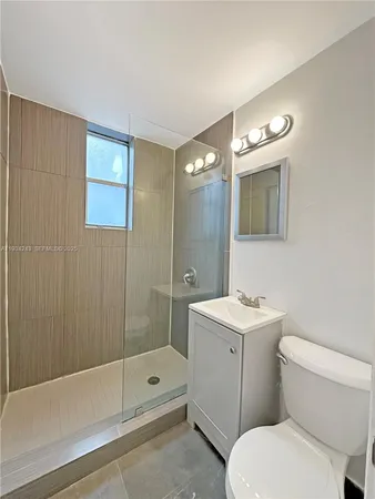 a bathroom with a toilet a sink and shower
